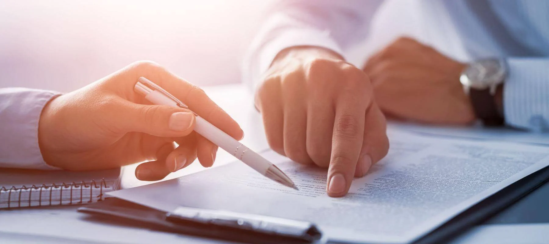 Lawyer helping client sign paper work
